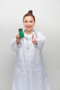 Happy woman showing thumb up and holding bottle with pills Royalty Free Stock Photo