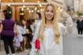 Happy woman showing thumbs up, like sign positive something good positive feedback in city street Royalty Free Stock Photo