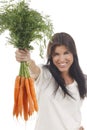 Happy woman shows on a bunch of carrots Royalty Free Stock Photo