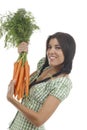 Happy woman shows on a bunch of carrots Royalty Free Stock Photo