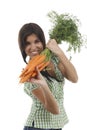 Happy woman shows on a bunch of carrots Royalty Free Stock Photo