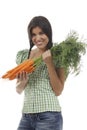 Happy woman shows on a bunch of carrots Royalty Free Stock Photo