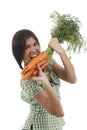 Happy woman shows on a bunch of carrots Royalty Free Stock Photo