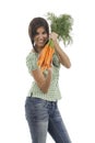 Happy woman shows on a bunch of carrots Royalty Free Stock Photo