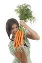 Happy woman shows on a bunch of carrots Royalty Free Stock Photo