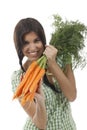 Happy woman shows on a bunch of carrots Royalty Free Stock Photo