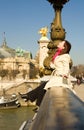 Happy woman sitting on the balustrade of a bridge Royalty Free Stock Photo