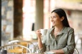 Happy woman in a coffee shop drinking contemplating Royalty Free Stock Photo