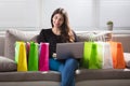 Happy Woman With Shopping Bags Using Laptop Royalty Free Stock Photo