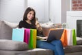 Happy Woman With Shopping Bags Using Laptop Royalty Free Stock Photo