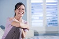 Happy woman sitting on couch smiling Royalty Free Stock Photo