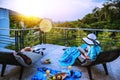 A happy woman sitting reading relaxing book on the balcony at home, summer on holiday drinking wine,orange juice and fruit on the Royalty Free Stock Photo