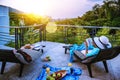 A happy woman sitting reading relaxing book on the balcony at home, summer on holiday drinking wine,orange juice and fruit on the Royalty Free Stock Photo