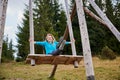 Swinging on giant wooden attraction outdoors at summer.