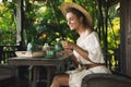 Happy woman sitting on the summer terrace and drinking coffee Royalty Free Stock Photo