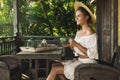 Happy woman sitting on the summer terrace and drinking coffee Royalty Free Stock Photo