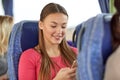 Happy woman sitting in travel bus with smartphone Royalty Free Stock Photo