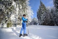 Happy woman skier on a ski slope in the forest Royalty Free Stock Photo