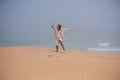 Happy woman skipping on walk along coast Royalty Free Stock Photo