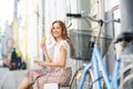 Happy woman with smartphone, bike and ice cream