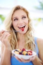 Happy woman, smile and fruit bowl for healthy diet, eating or fiber nutrition outdoors. Female person smiling in