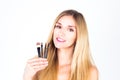 Happy woman with smile is holding cosmetic brushes. Make-up Royalty Free Stock Photo