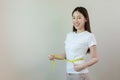 Happy woman smile measures her waist size with tape measure. Royalty Free Stock Photo