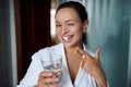 Happy woman smiles at camera, taking pills for antidepressant therapy. Mental health. Treating depression, panic attacks