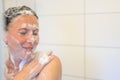 Happy woman smiling as she enjoys a shower