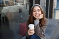 Happy woman smiling and drinking coffee in the city Royalty Free Stock Photo