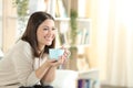 Happy woman smiling drinking coffee at home Royalty Free Stock Photo