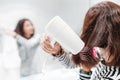 Happy woman smiling and drying her hair with hairdryer near the mirror in the bathroom Royalty Free Stock Photo