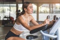 Happy woman smiling during exercising on bike machine at gym sport club Royalty Free Stock Photo