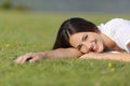 Happy woman smiling and resting relaxed on the grass Royalty Free Stock Photo