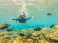 Happy woman in snorkeling mask dive underwater with tropical fishes in coral reef sea pool. Travel lifestyle, water Royalty Free Stock Photo