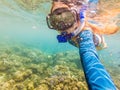 Happy woman in snorkeling mask dive underwater with tropical fishes in coral reef sea pool. Travel lifestyle, water Royalty Free Stock Photo