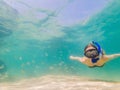 Happy woman in snorkeling mask dive underwater with tropical fishes in coral reef sea pool. Travel lifestyle, water Royalty Free Stock Photo