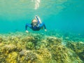 Happy woman in snorkeling mask dive underwater with tropical fishes in coral reef sea pool. Travel lifestyle, water Royalty Free Stock Photo