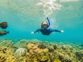 Happy woman in snorkeling mask dive underwater with tropical fishes in coral reef sea pool. Travel lifestyle, water Royalty Free Stock Photo