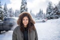 Happy woman with a snowy forest as background