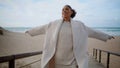 Happy woman spinning open arms on ocean beach. Smiling cheerful model walking Royalty Free Stock Photo