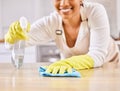 Happy woman, spray bottle and hands cleaning table in housekeeping, hygiene or disinfection in kitchen. Closeup of