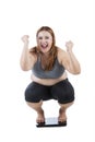 Happy woman squat on weight scale