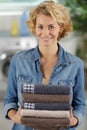 Happy woman stacking clean towels Royalty Free Stock Photo