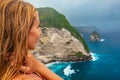 Happy woman stand at high cliff under rainy sky