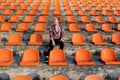 Happy woman standing in amongst the rows of empty seats at stadium cheering with her arms raised punching air Royalty Free Stock Photo