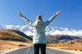 Happy Woman Standing On Empty Road and Looking on Mountains.