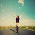 Happy woman standing on empty road. Retro vintage style Royalty Free Stock Photo