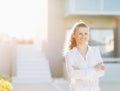 Happy woman standing in front of house building Royalty Free Stock Photo