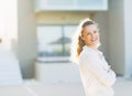 Happy woman standing in front of house building Royalty Free Stock Photo